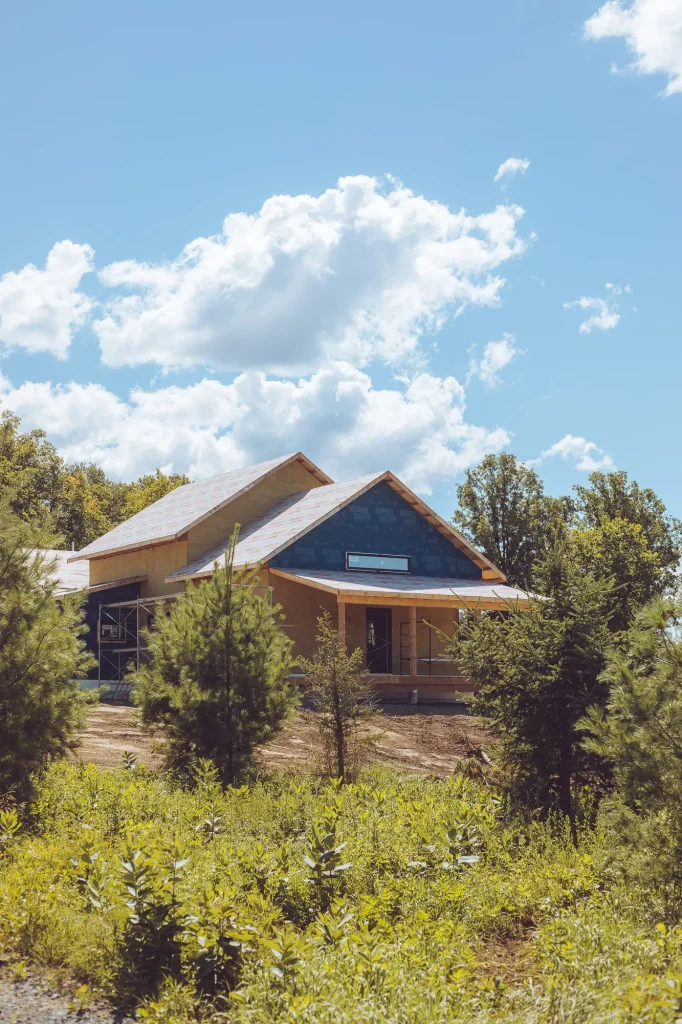 Adhero house wrap and rockwool being applied to the exterior of the house.